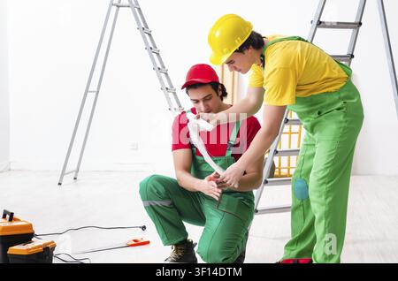 Injured worker and his workmate Stock Photo