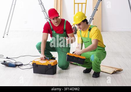 Two workers contractors working indoors Stock Photo