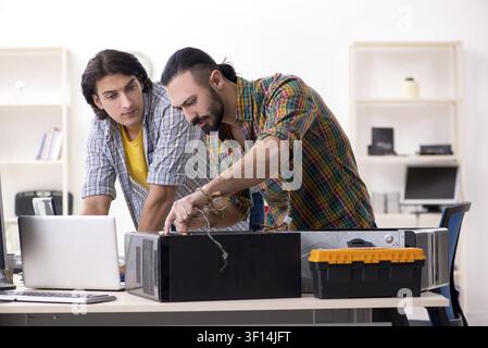 IT engineers working on hardware issue Stock Photo