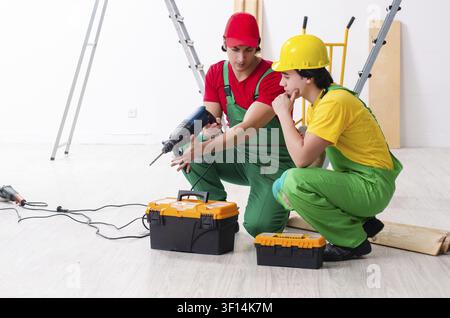 Two workers contractors working indoors Stock Photo