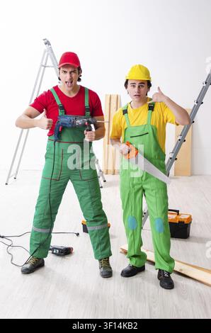Two workers contractors working indoors Stock Photo
