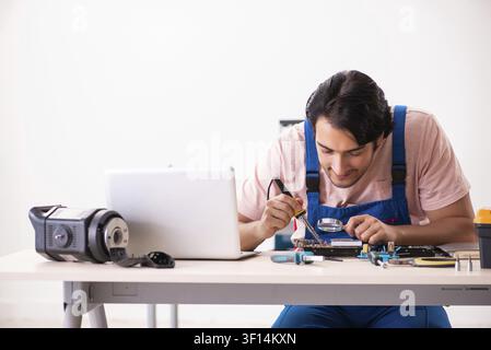 Young male contractor repairing computer Stock Photo