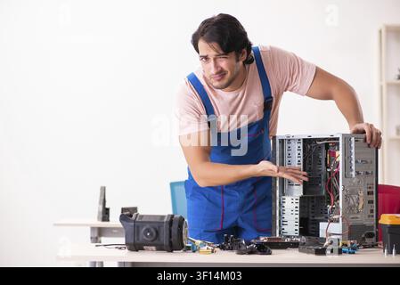 Young male contractor repairing computer Stock Photo
