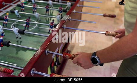 People Playing Table Football in Recreation Room Close Up Stock Photo