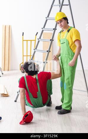 Injured worker and his workmate Stock Photo