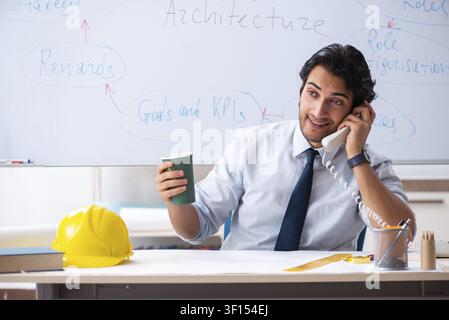 Young male architect in front of the whiteboard Stock Photo
