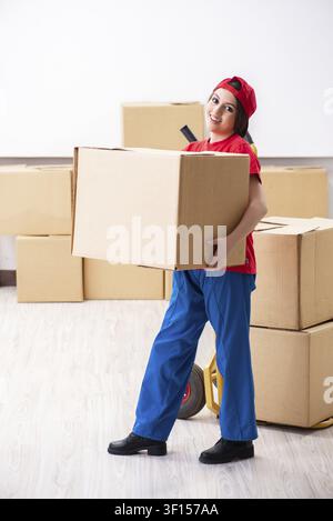 Young female professional mover doing home relocation Stock Photo