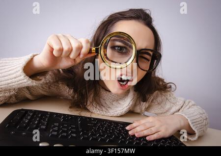 Funny nerd girl working on computer Stock Photo