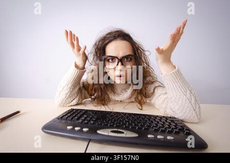 Funny nerd girl working on computer Stock Photo