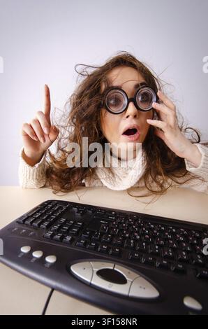 Funny nerd girl working on computer Stock Photo