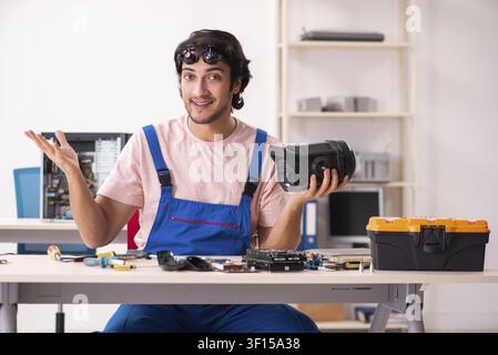 Young male contractor repairing computer Stock Photo