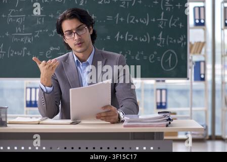 Young handsome math teacher in classroom Stock Photo