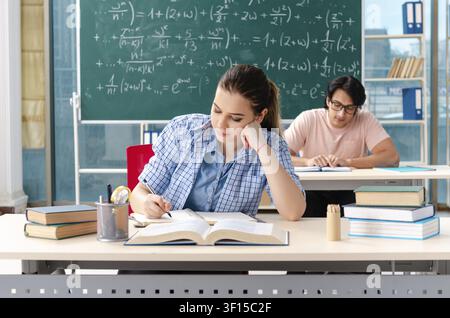 Young students taking the math exam in classroom Stock Photo