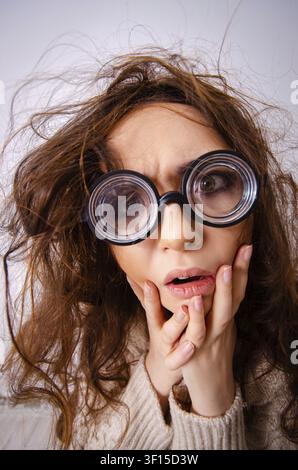 Funny nerd girl working on computer Stock Photo