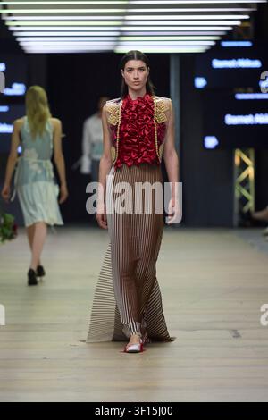 Berlin, Germany, 2nd Jul, 2026. A model walks the runway for designer Samet Akkus at Neo Fashion during Berlin Fashion Week, wearing a pleated gown. Stock Photo