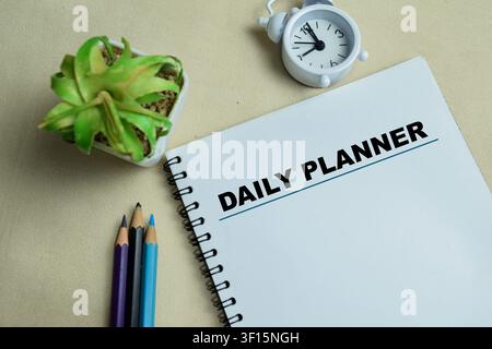 Concept of daily planner write on book isolated on Wooden Table. Stock Photo