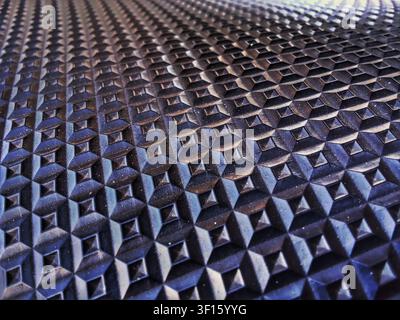 Close-up Perspective of Black Textured Rubber Surface with Geometric Square Patterns Stock Photo