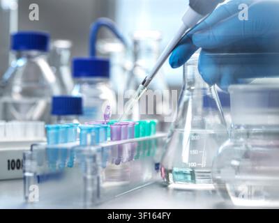 Genetic research, conceptual image. Scientist extracting samples using a pipette for analytical testing in the lab. Stock Photo