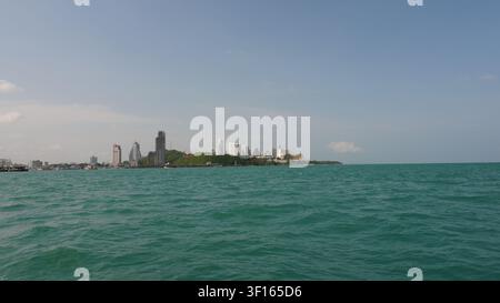 Wide Green Ocean Water View Distant Pattaya Urban Skyline Background Pale Clear Cloudy Sky Stock Photo