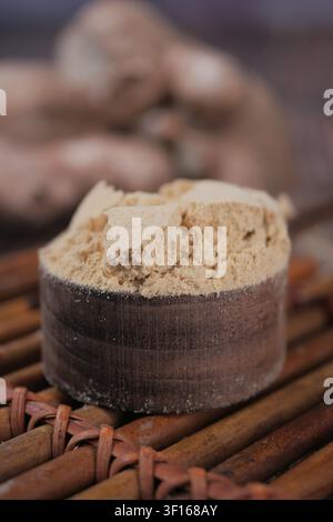 Freshly ground ginger powder on a wooden surface Stock Photo