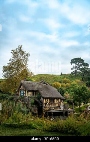 Scenic view of the historic Mill House and waterwheel at the Hobbiton Movie Set in Matamata, New Zealand. Stock Photo