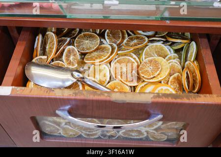 Deliciously arranged dried orange slices in a wooden drawer Stock Photo