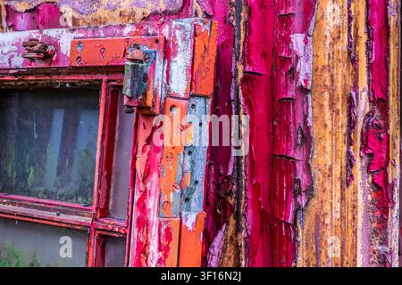 Peeling paint texture on aged telephone box door hinge detail Stock Photo