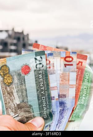 Jordanian dinar banknotes in hand, economy finance cash concept, real estate investment background. Ayla. Holidays in Jordan, red sea vacation, proper Stock Photo