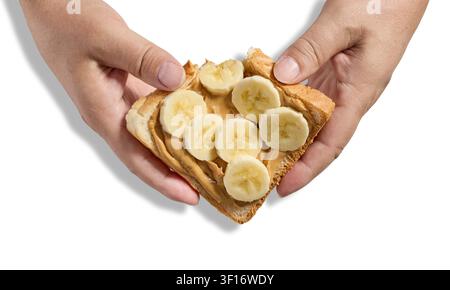 toast slice with peanut butter and banana in human hands isolated on white background Stock Photo