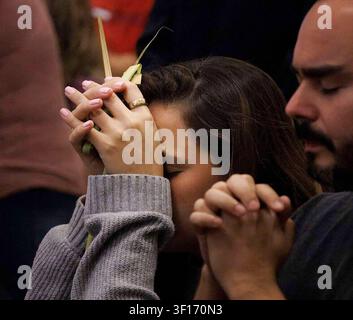 Miami, United States. 10th July, 2026. A woman prays with palms clasped in her hands after receiving communion during Palm Sunday Mass at the Cathedral of St. Mary in Miami on March 29, 2026. Palm Sunday marks the beginning of Holy Week in the Catholic liturgical calendar, commemorating Jesus Christ's entry into Jerusalem. (Photo by Miami Herald/Miami Herald/TNS/Sipa USA) Credit: Sipa USA/Alamy Live News Stock Photo