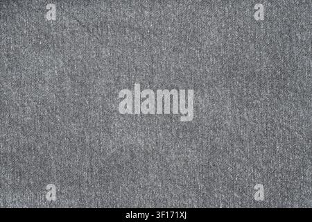 Close up of gray textile with fine woven texture and even lighting. Neutral tone and soft surface ideal for design overlays or backgrounds. Minimalist Stock Photo