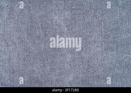 Textured blue fabric fills frame with subtle weave pattern soft lighting. Neutral tone uniform surface ideal for design overlays, product displays, mi Stock Photo