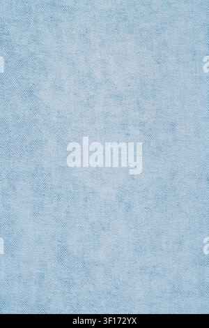 Close up of light blue denim fabric with visible weave pattern subtle texture. Soft even lighting highlights natural fibers. Ideal for fashion, textil Stock Photo
