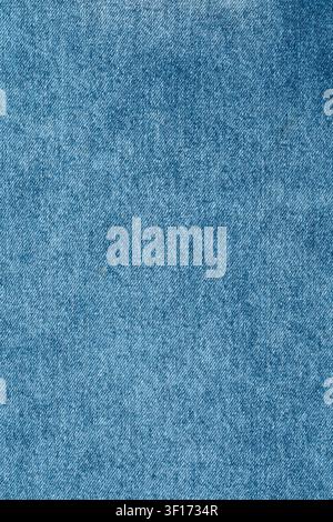 Extreme closeup of light blue denim fabric. Detailed twill weave pattern of classic jeans material creates textured background. Perfect for fashion or Stock Photo