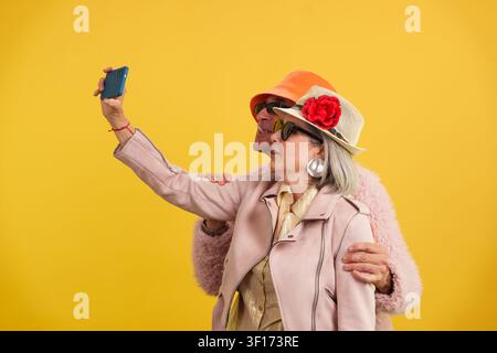 Stylish senior couple enjoying selfie and active maturity Stock Photo