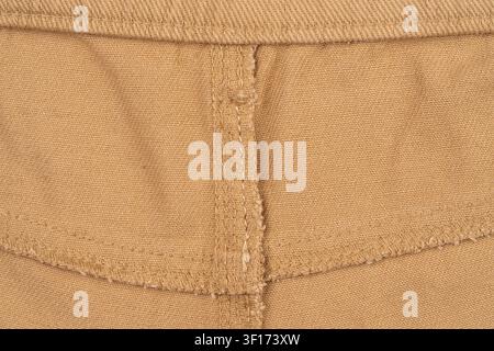 Detailed macro shot of tan woven fabric showing texture, stitching, seam construction. Neutral color palette with soft even lighting. Ideal for design Stock Photo