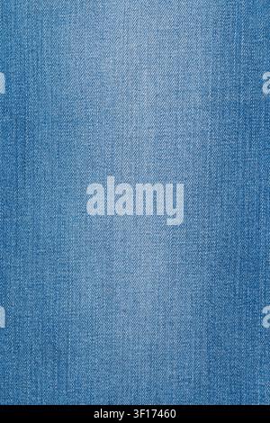 Closeup view of light blue denim fabric. Detailed texture shows classic diagonal twill weave. Soft lighting creates subtle gradient. Perfect backgroun Stock Photo