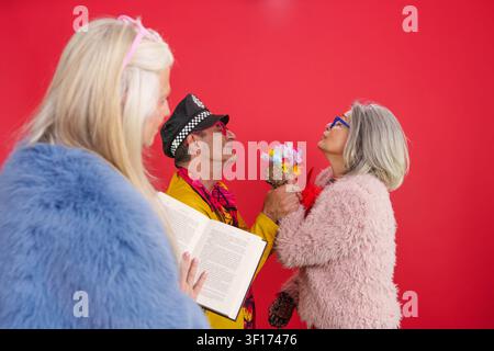 Mature couple celebrating love and active longevity with flowers Stock Photo