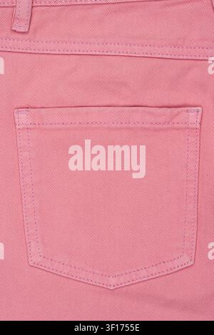 Macro shot of pink denim pants back pocket. Shows detailed fabric texture and stitching. Clean, flat lay composition. Concept for fashion, textile, or Stock Photo