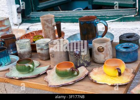 Assorted multi coloured Handcrafted Ceramics Displayed on Rustic Wooden Tab Stock Photo