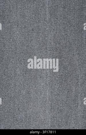 Macro shot of dark grey or charcoal colored fabric. Detailed woven texture shows diagonal twill pattern. Neutral, minimalist background for design, fa Stock Photo