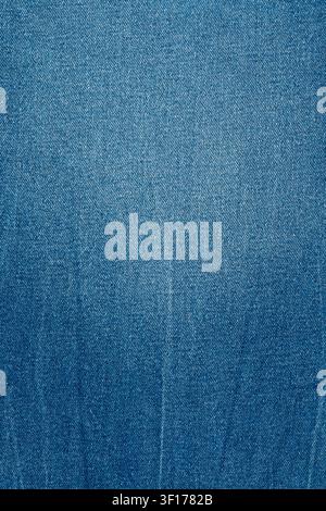 Closeup detail of blue denim fabric showing classic diagonal twill weave and texture. Color features gradient from light to dark blue, perfect as vers Stock Photo