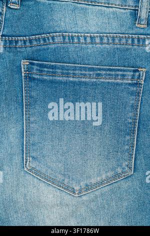 Detailed close up of back pocket on classic blue jeans. Denim fabric shows visible texture and wear with contrast stitching. Perfect background for fa Stock Photo