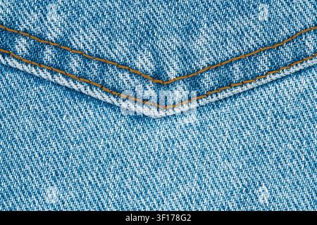 Blue denim jeans pocket close up. Texture of fabric with textile stitching. Cotton material construction, casual clothing detail. Material for fashion Stock Photo