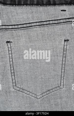 Monochrome closeup of denim jeans back pocket highlighting texture stitching. Minimalist composition with neutral tones Stock Photo