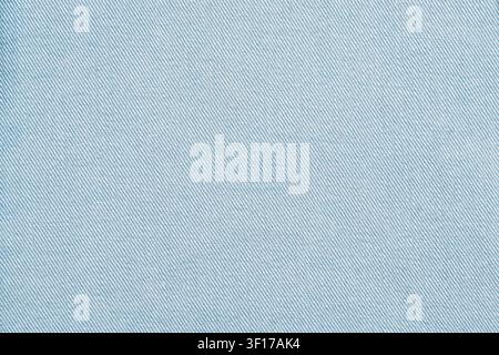 Close up of light blue woven textile with diagonal grain pattern. Soft even lighting highlights texture. Neutral minimal background ideal for design o Stock Photo