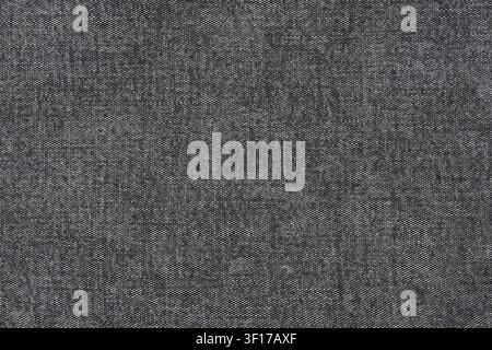 Detailed macro view of dark gray woven fabric with fine texture subtle tonal variations. Neutral color palette uniform pattern suitable for background Stock Photo
