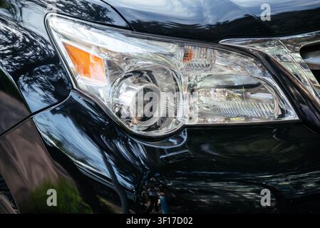 Close-up of the headlight of a modern car. Car front optics. Car headlight.  Stock Photo