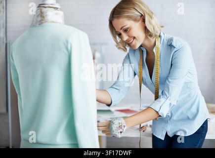 Check, fabric and woman with mannequin in startup, adjusting or fashion designer with measuring tape. Design, seam and happy person with sewing Stock Photo