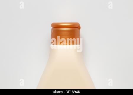 A close-up of a plastic bottle with a flip-top lid on a white background, used for cosmetics, household chemicals, or food packaging Stock Photo